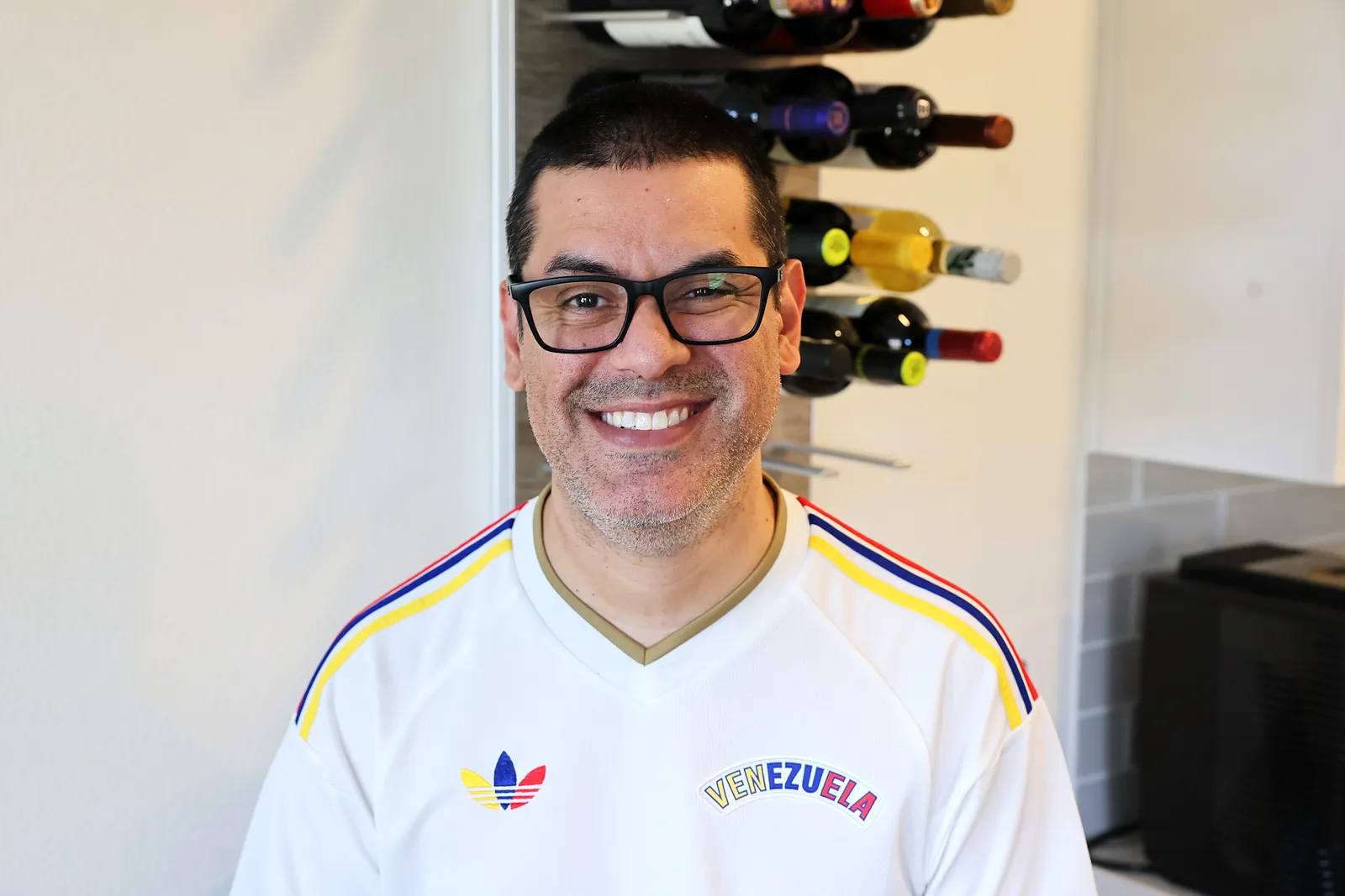 David smiling in a white Venezuela jersey with the yellow, blue, and red tricolor